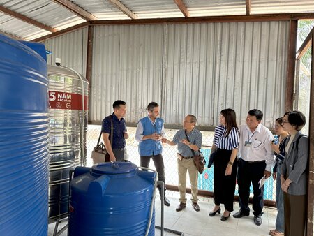 Local counterparts and WHO staff visiting the new water treatment plant