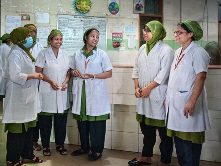 Duty nurses gather before attending to patients in the dengue wards at Dhaka Medical Hospital on September 24, 2023.